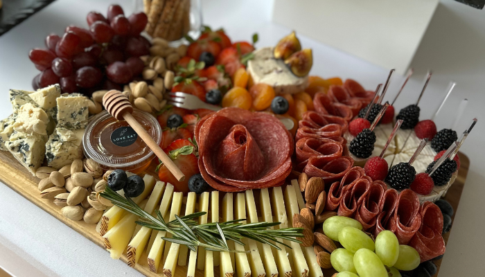 Grazing table with charcuterie, cheeses, fruits and bread